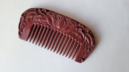Carved purple heart wood comb with a centered lotus flower on one side.  Lotus flower is a favorite flower in many Asian countries.