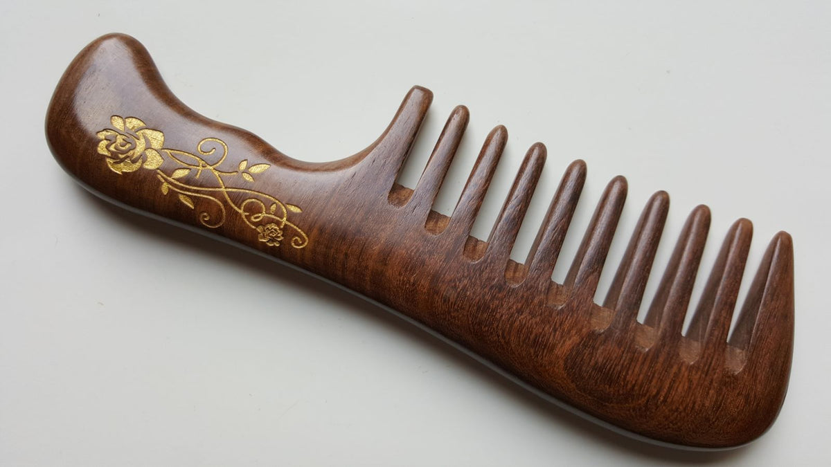 Rose wood comb with gold floral motif — made from natural Sucupira hardwood, curved shape
