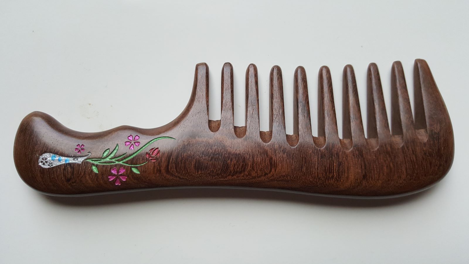 A dark brown wooden comb with a floral design on the handle. The flowers vase design is in impressionist style. Gift for Her