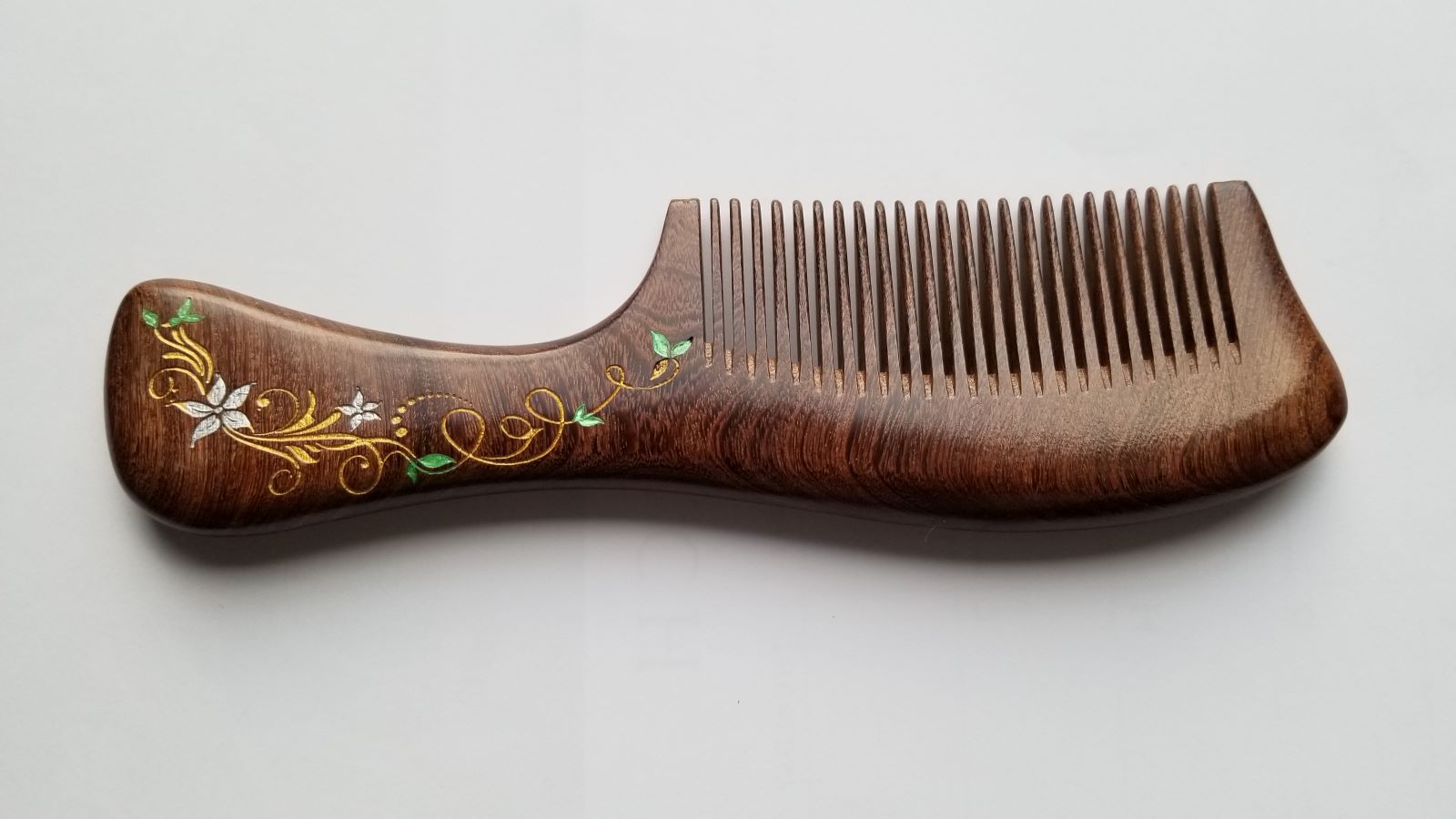 A brown wooden comb with a decorative ivy design. The comb has a long ergonomic handle and a extra wide, rounded tooth. comes with gift bag and Gift for women