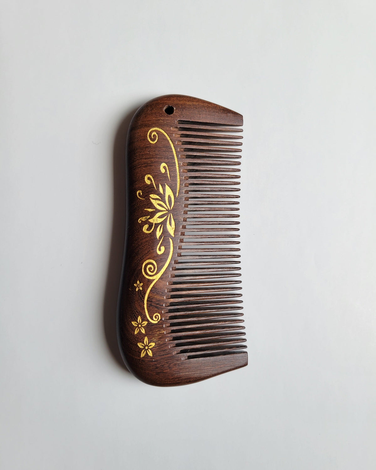 Aiko Lotus Wood Comb — hand-painted lotus motif on dark brown Sucupira hardwood, anti-static fine tooth pocket comb