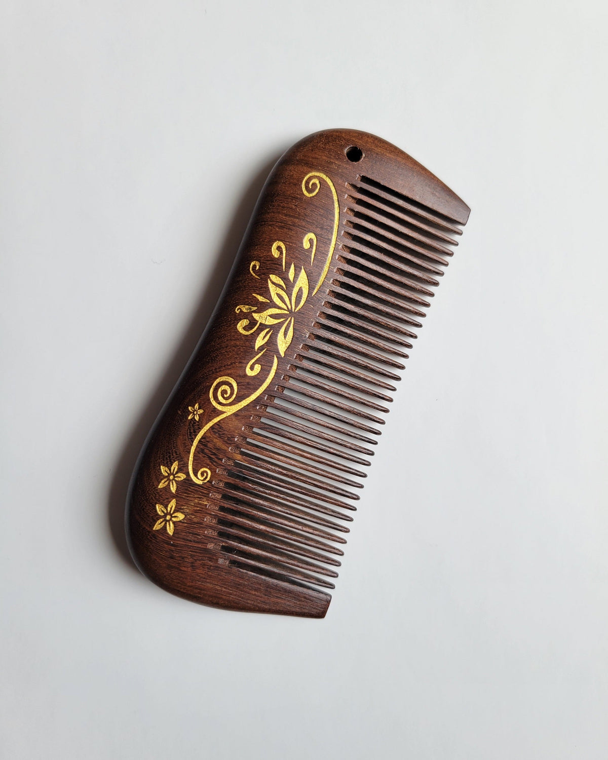 Hand-painted gold lotus motif on natural Sucupira wood comb — artisan gift for lotus flower lovers