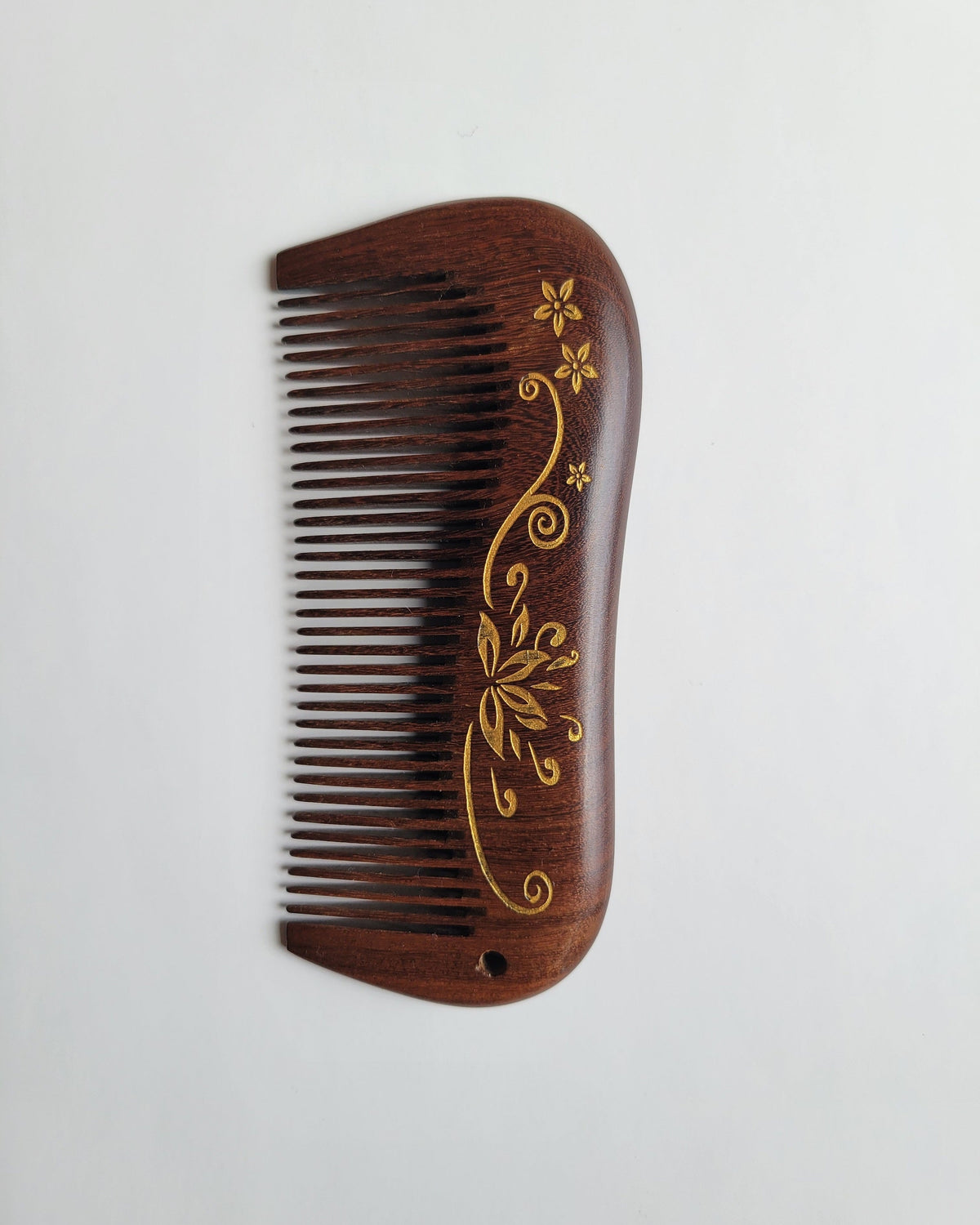 Aiko Lotus Wood Comb side profile — curved handle, fine teeth, vintage-style lotus motif on dark brown hardwood