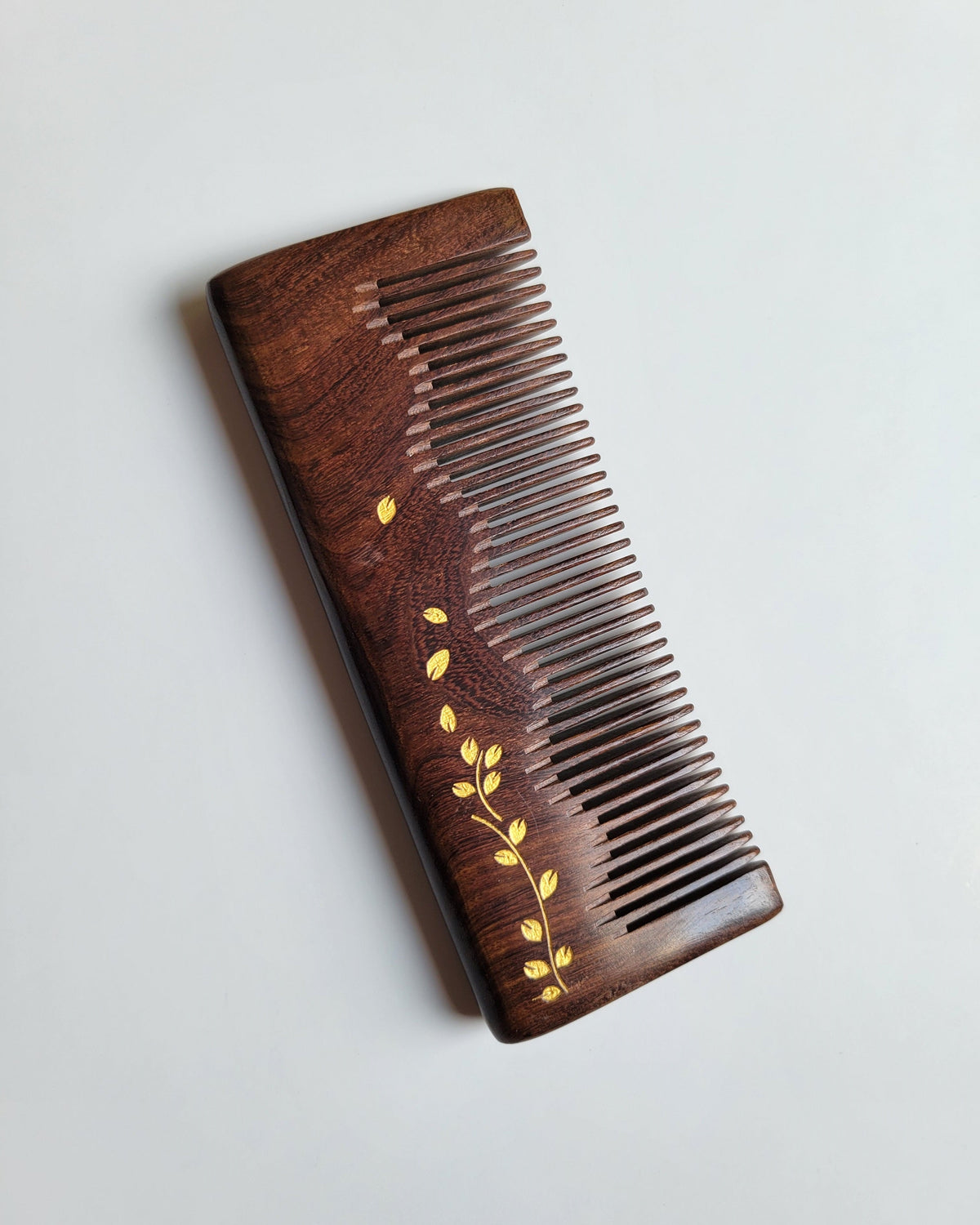Straight ivy vine wood comb — gold hand-painted motif on dark Sucupira hardwood, fine teeth
