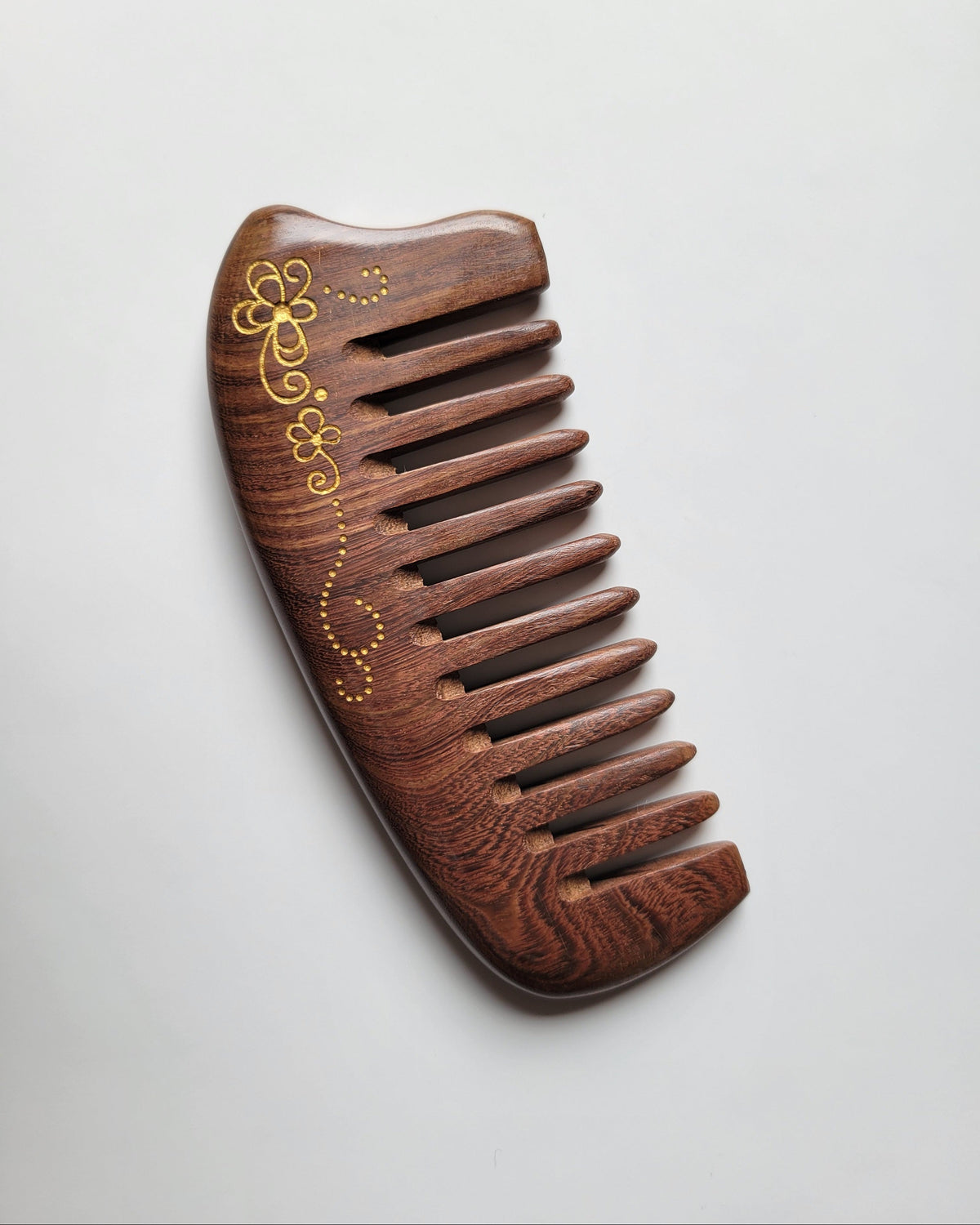 Hand-painted floral scroll Sucupira comb with comfortable no-handle grip, anti-static hardwood, distributes natural hair oils for shine