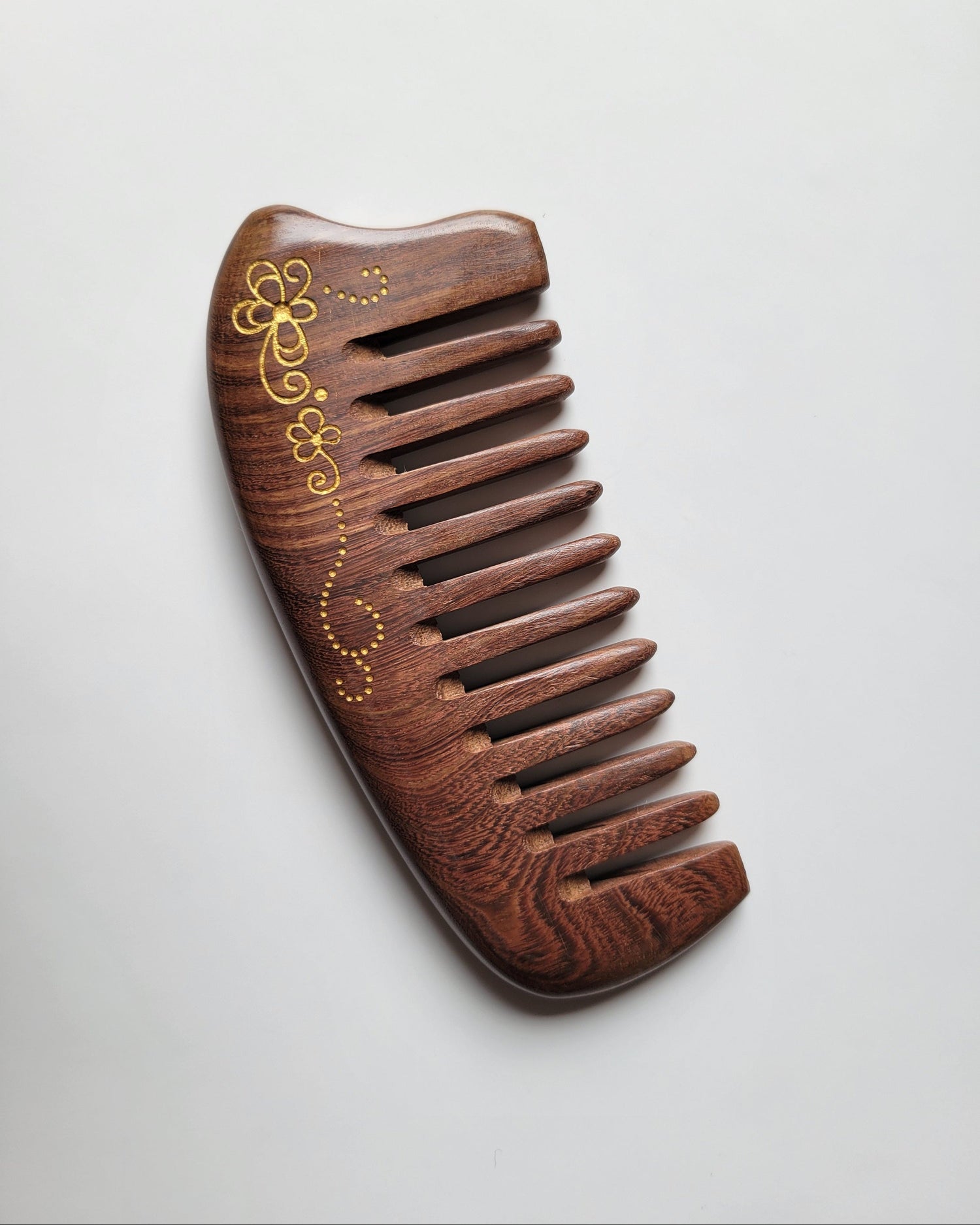 Hand-painted floral scroll Sucupira comb with comfortable no-handle grip, anti-static hardwood, distributes natural hair oils for shine