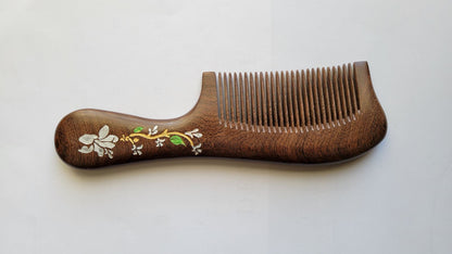 Brown Sucupira wood fine tooth comb with floral painted handle, flat lay side angle — Arakicrafts