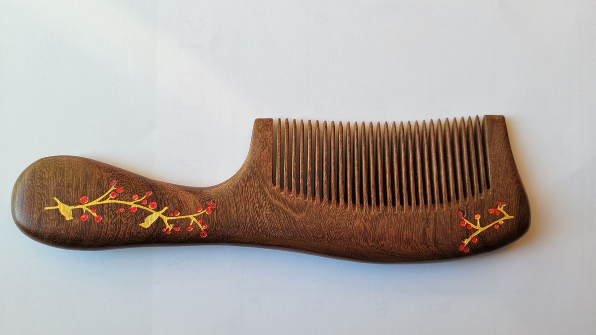 Back view of Sucupira hardwood fine tooth comb, rich dark chocolate-brown grain, single-piece hardwood construction with ergonomic handle