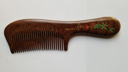Sucupira wood comb with red plum blossom design on handle, fine teeth, curved silhouette — Arakicrafts