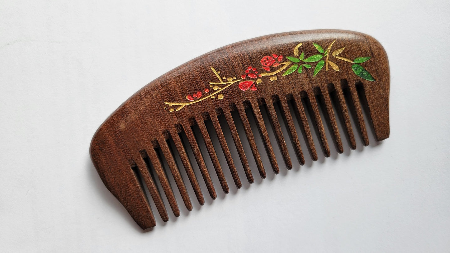 Natural hardwood pocket comb for women — red plum blossom and gold accents on dark Sucupira wood — Arakicrafts