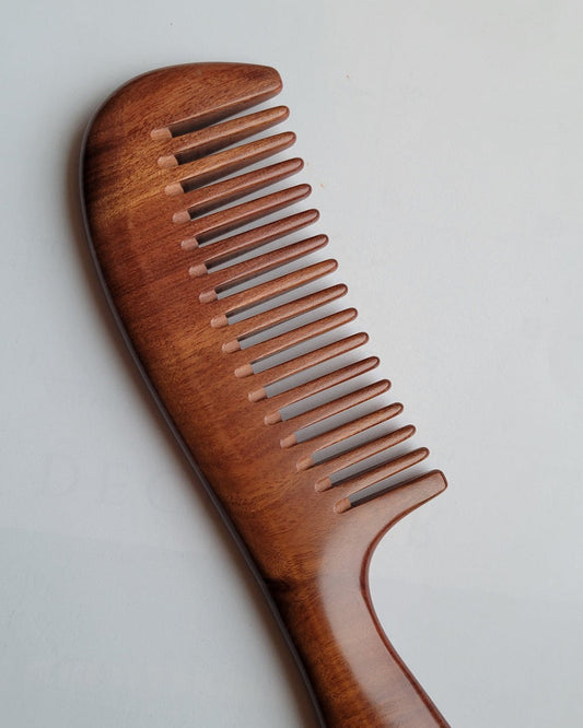 African Mopane wide tooth wood comb with handle, flat lay front view — Arakicrafts