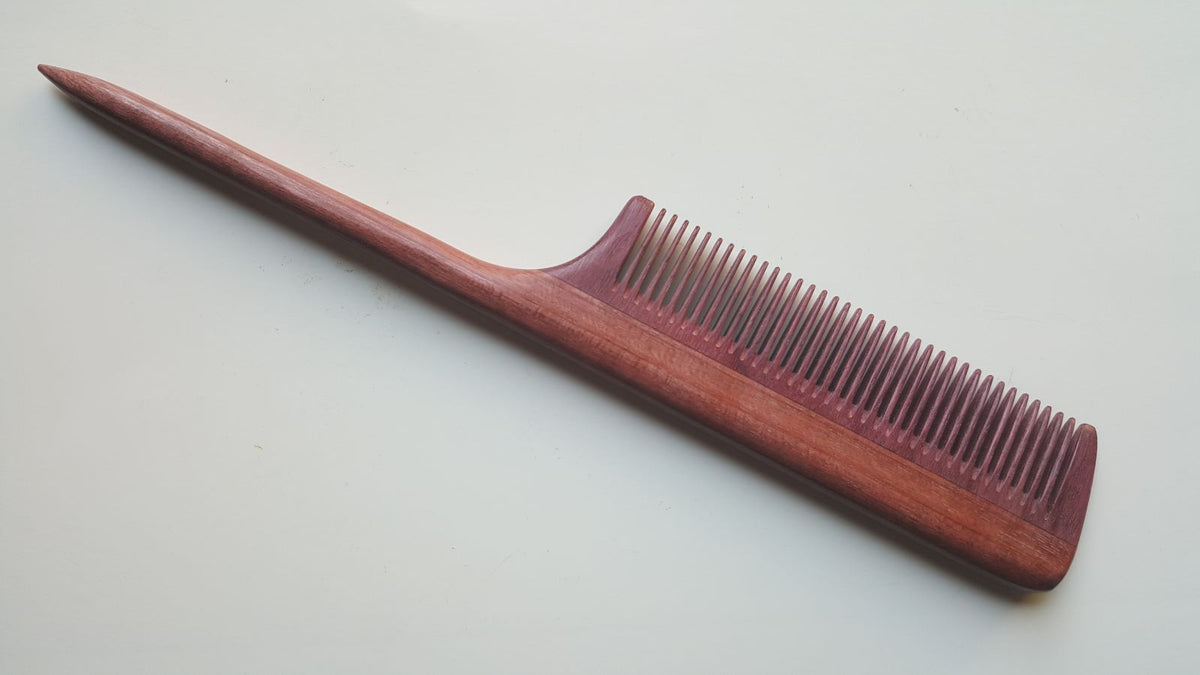 handcrafted rat tail wood comb with fine teeth, purple heart wood, beautiful pine tone wood grain. designed for precision sectioning and hair styling
