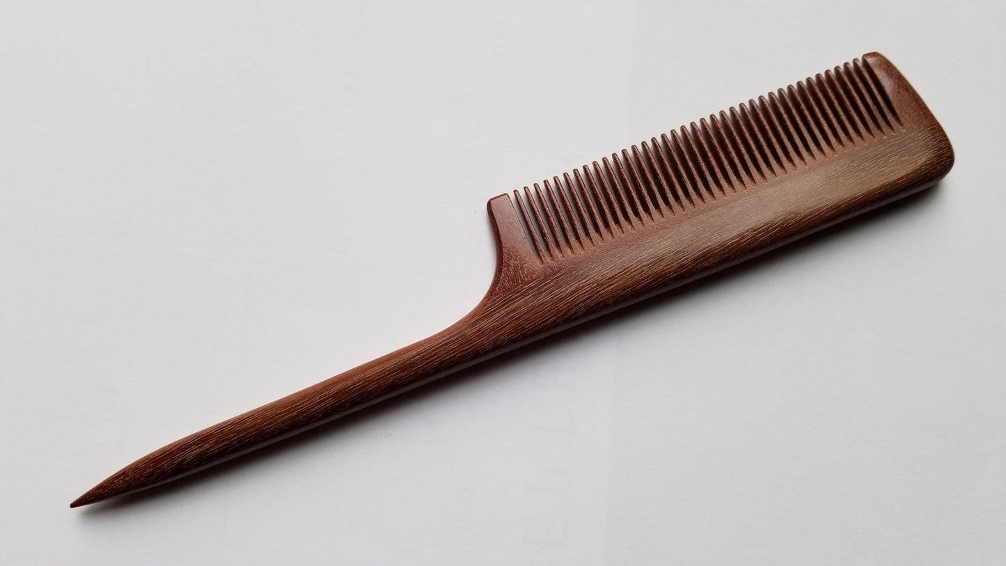 A long, thin, wooden comb with a dark brown color and a fine-toothed comb on one end. The comb has a long, thin handle. Perfect gift for her