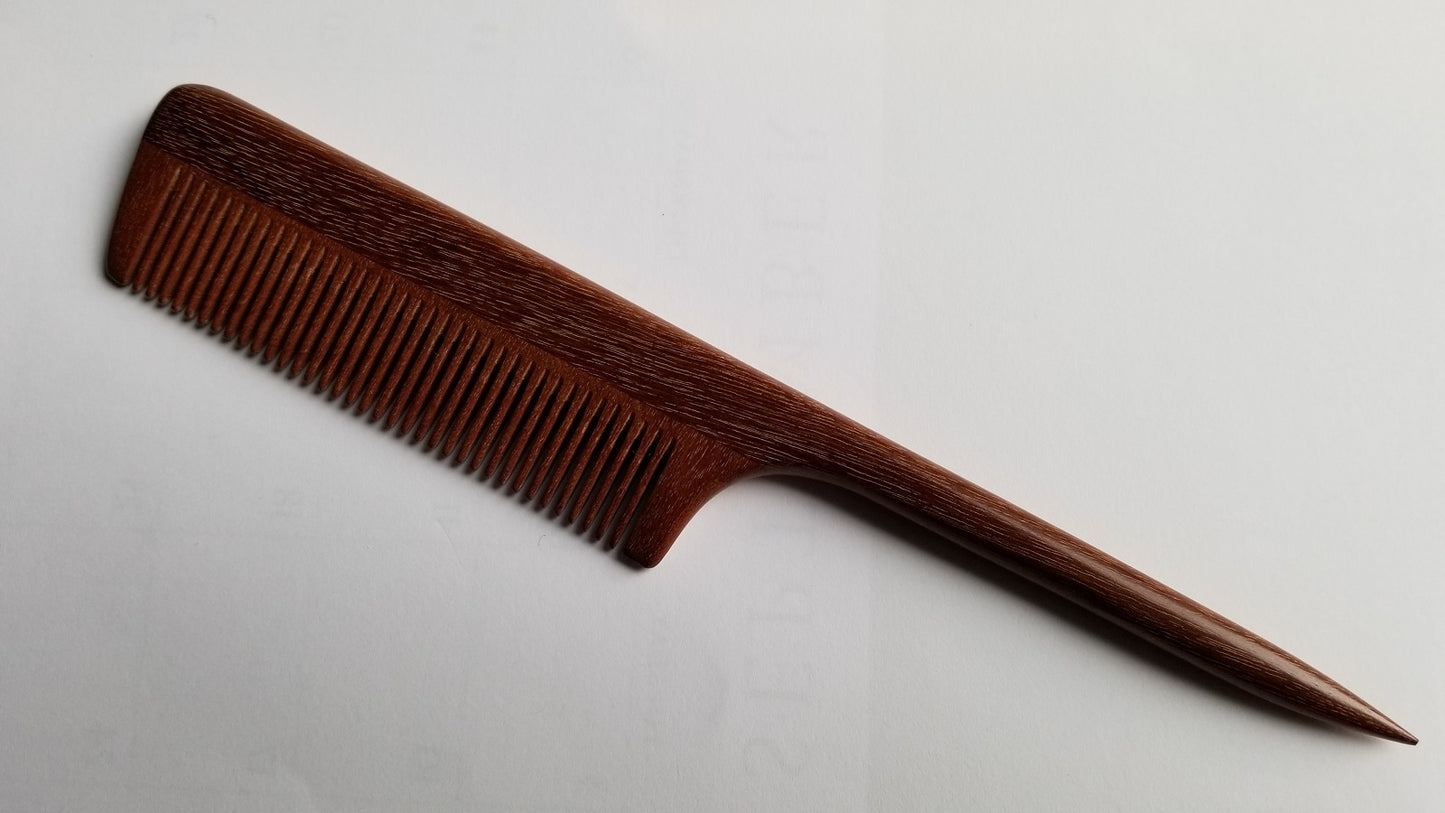 A rat tail wooden comb with a long, thin handle. The comb is brown and has a natural wood finish. Anti-static, Eco-friendly gift