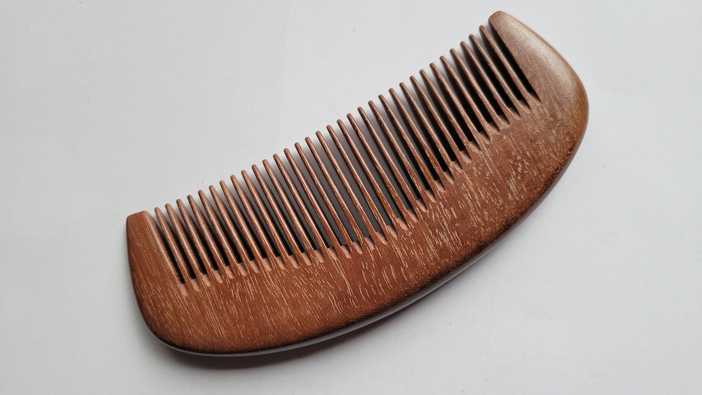Handcrafted pocket comb with curved silhouette — handle and fine teeth in single-piece Pau Rosa hardwood — Arakicrafts