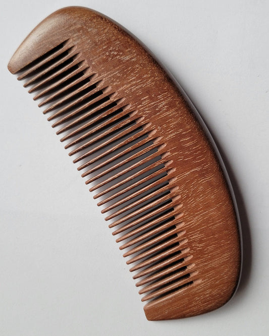 Handcrafted pocket comb with curved silhouette — handle and fine teeth in single-piece Pau Rosa hardwood — Arakicrafts
