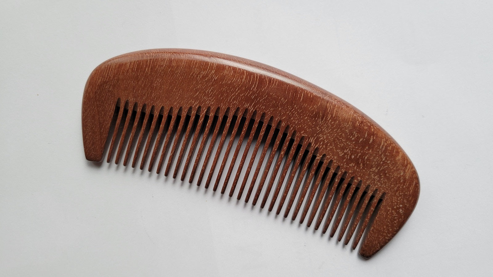 Anti-static fine tooth wood comb for straight, fine, and short hair, flat lay overhead view — Arakicrafts