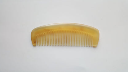 minimalist sheep horn comb with a curved shape and fine teeth for short hair and mustache. 