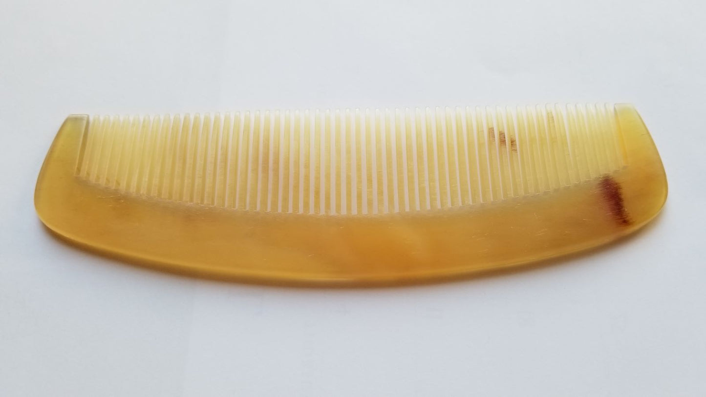 A vintage style sheep comb with a curved handle. The comb has fine teeth and is designed for daily hair grooming - Front view