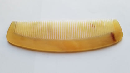 A vintage style sheep comb with a curved handle. The comb has fine teeth and is designed for daily hair grooming - Front view