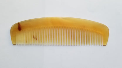 A vintage style curved comb made of sheep horn. The comb has fine teeth and a smooth, polished surface. It helps to reduce static and distributes hair oil naturally. bio-degradable and Eco-friendly 