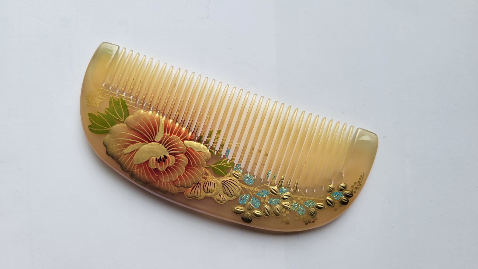 Translucent amber sheep horn comb with full-bloom lacquered peony, green leaf detail, Chinese natural lacquer craft hair comb