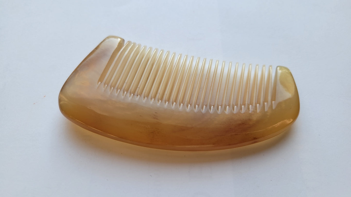 Extra-thick sheep horn massage comb, warm amber translucent horn, crescent silhouette with smooth arched spine for scalp massage