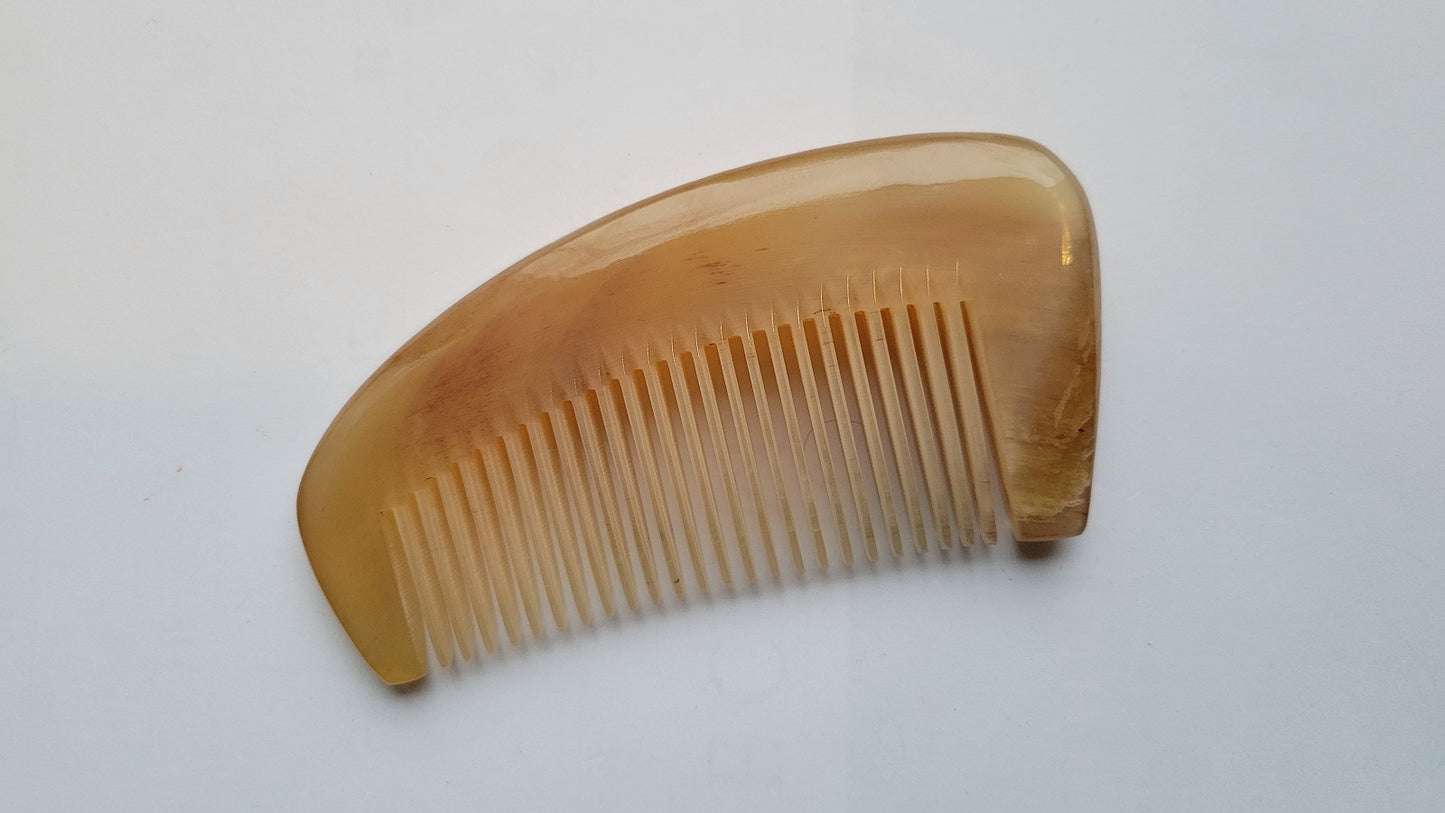 Deep amber sheep horn massage comb, natural grain variation, extra-thick crescent body, handcrafted natural horn grooming tool