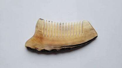 Rustic sheep horn comb — flat lay three-quarter angle, full comb visible