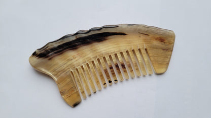 Natural sheep horn wide-tooth comb — overhead flat lay, full length