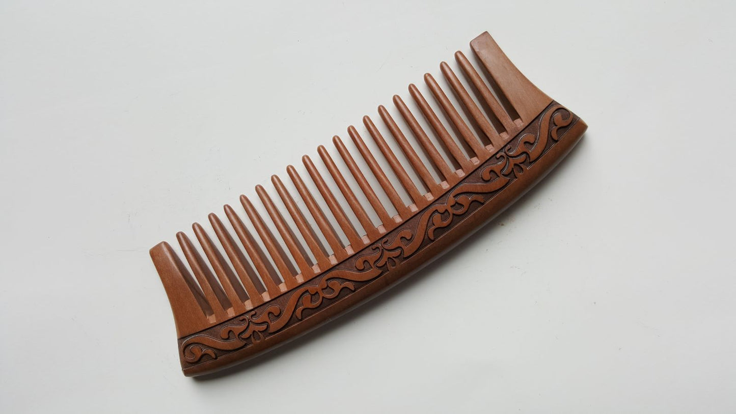 vintage style peach wood wooden comb with a carved karakusa design. The comb has evenly spaced wide teeth and can detangle the curly hair and beard for your daily hair care routine. 