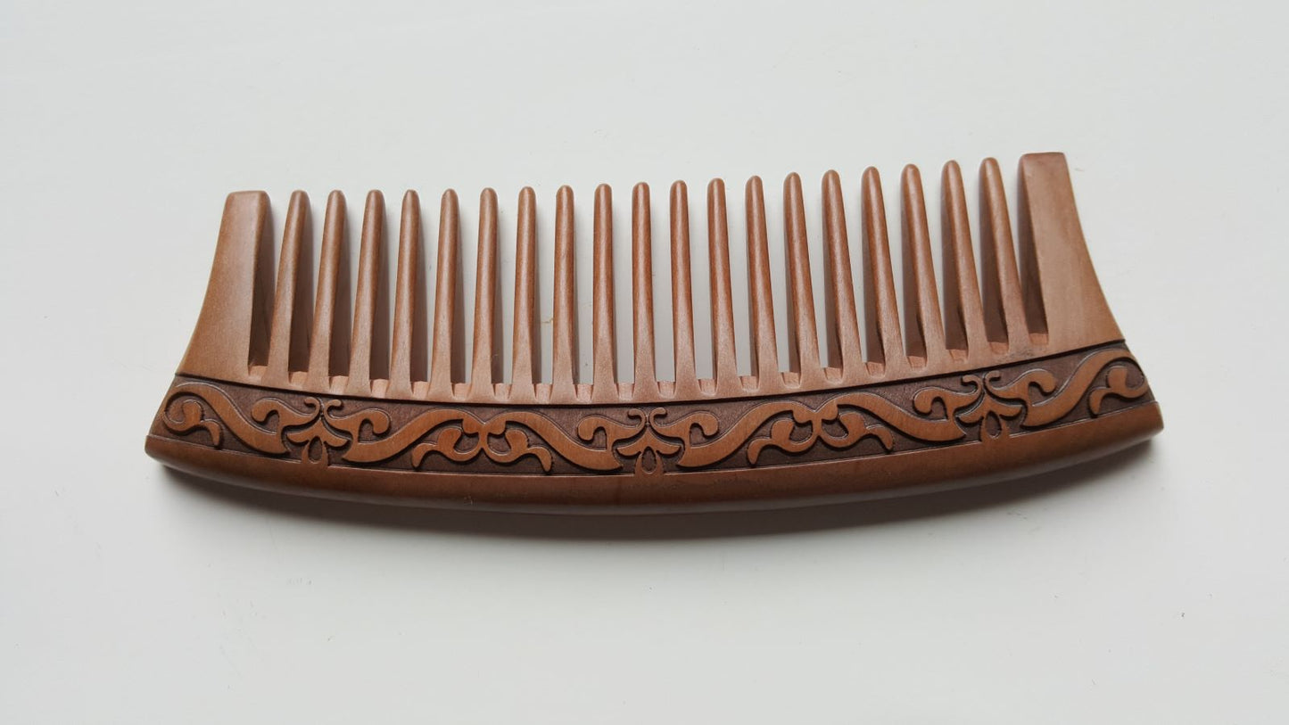 Brown peach wood comb with decorative patterns. must have for healthy hair care. 