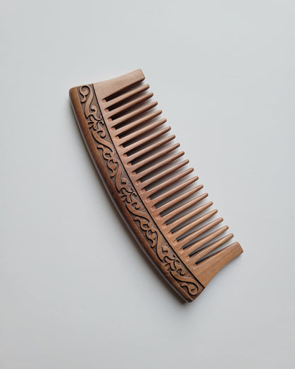Brown peach wood comb with decorative patterns. must have for healthy hair care. 