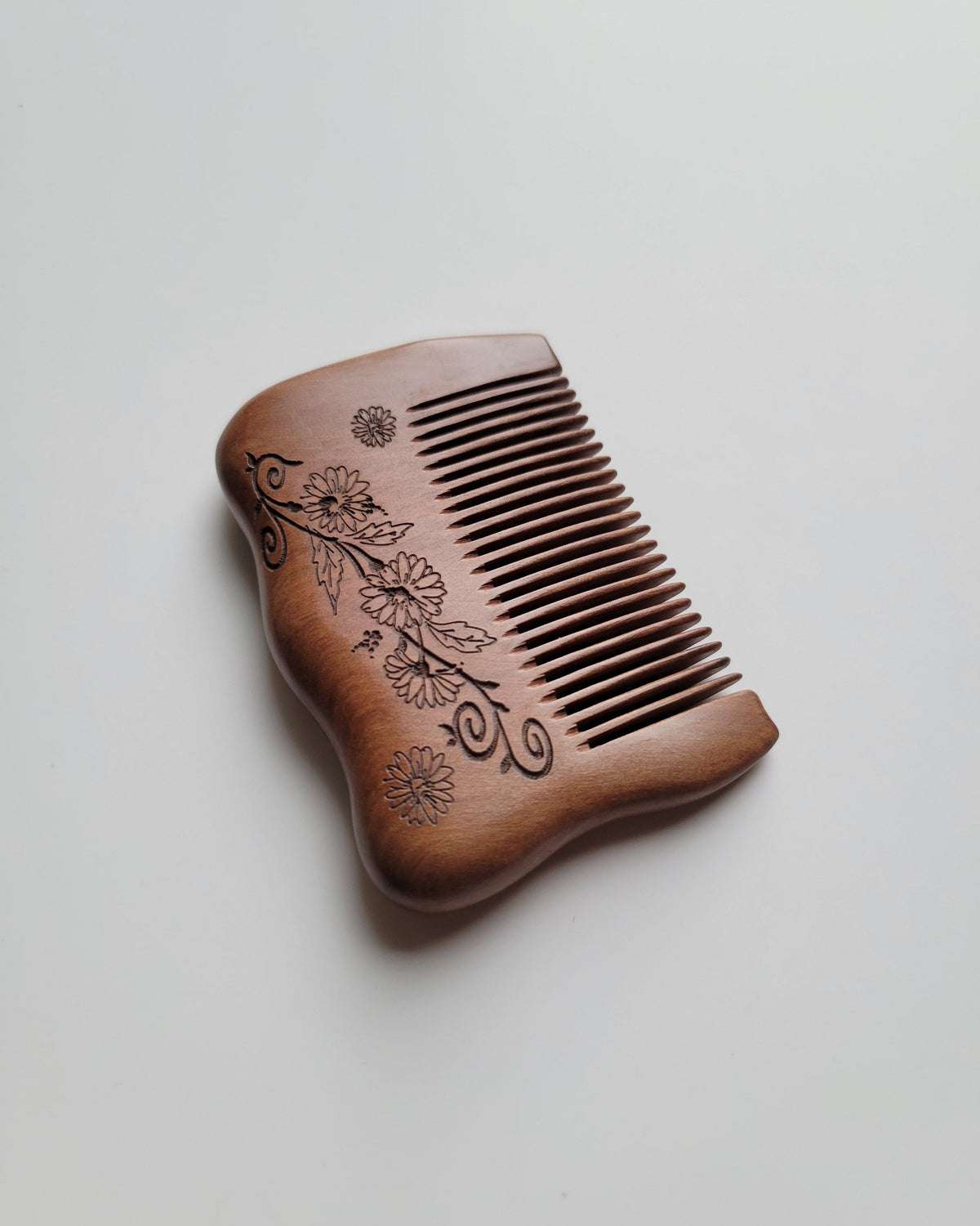 Pocket-sized floral wood comb measuring 3.1 inches long, with rounded edges and a hand-carved flowering vine. birthday gift for girl friends
