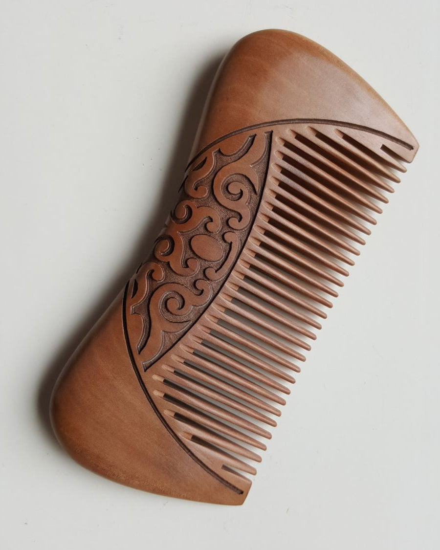 Karakusa peach wood comb showing engraved vine pattern detail