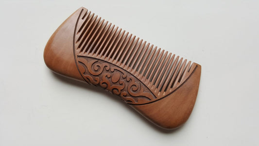 Karakusa peach wood comb showing engraved vine pattern detail