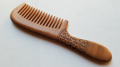 Essential Peach Wood long-handle comb with hand carved Celtic-inspired spiral vine pattern, flat lay front view — Arakicrafts