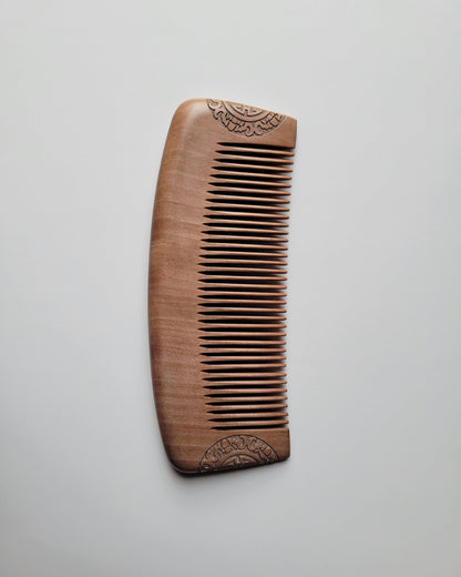 A Classic Peach Wood Comb showing its smooth curved spine and rounded edges. Gift for new boyfriend. 
