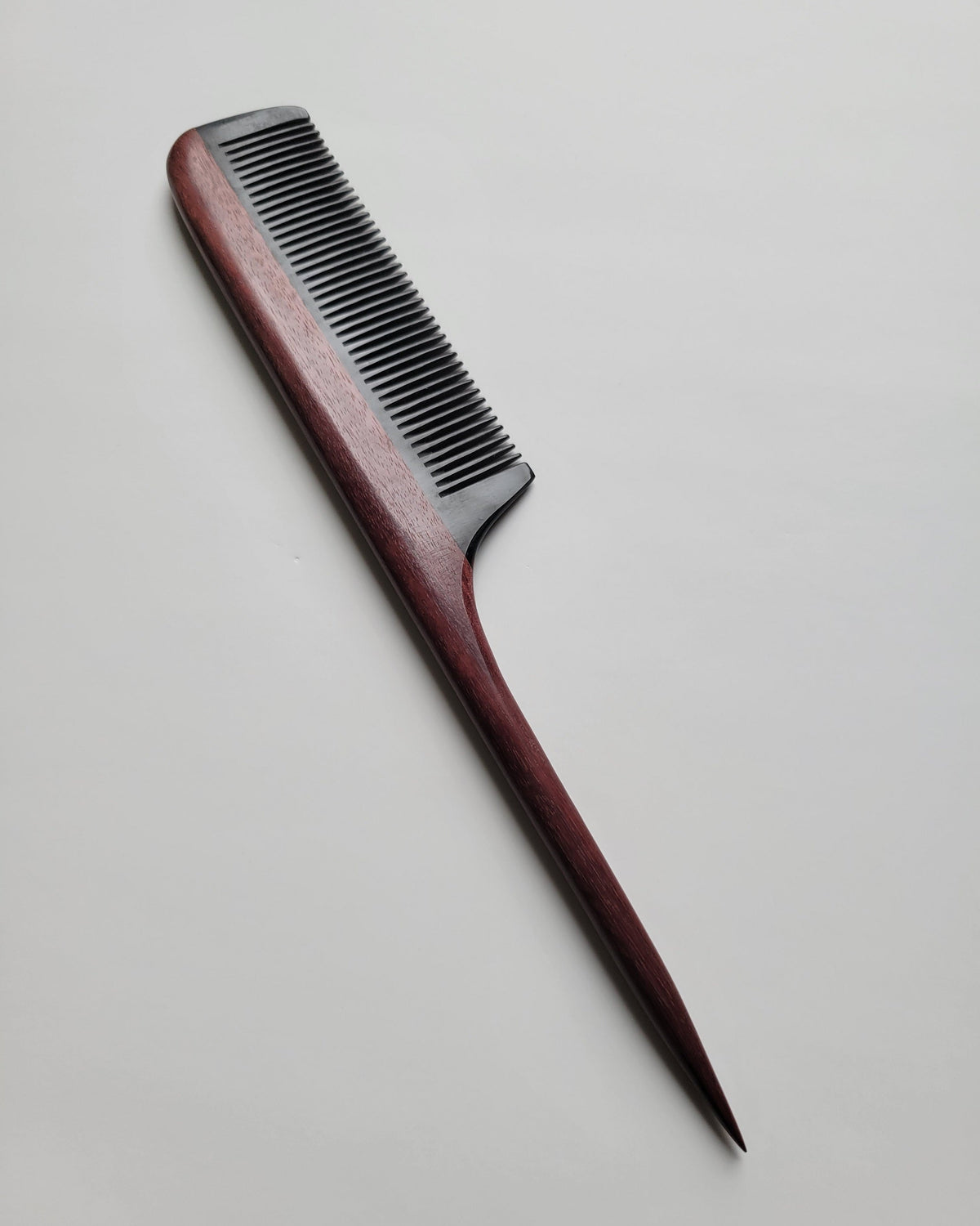 Rat tail comb side profile showing purple heart handle depth and buffalo horn inlay, fine 0.12 cm teeth for all hair types