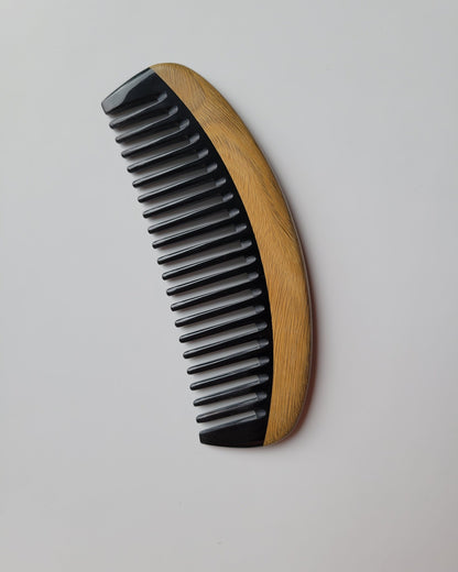 Classic Sandalwood Wide Teeth Horn Comb flat lay — three-quarter view showing no-handle design and wide tooth spacing