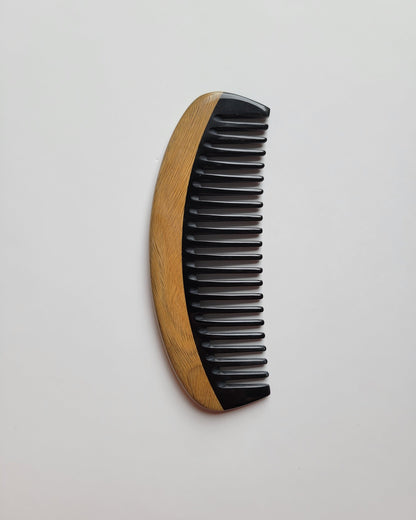Classic Sandalwood Wide Teeth Horn Comb flat lay — angled view emphasizing green sandalwood color and horn contrast