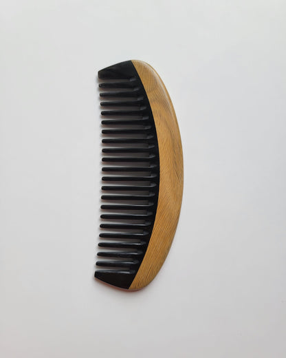 Classic Sandalwood Wide Teeth Horn Comb flat lay — diagonal angle showing natural wood grain and wide buffalo horn teeth