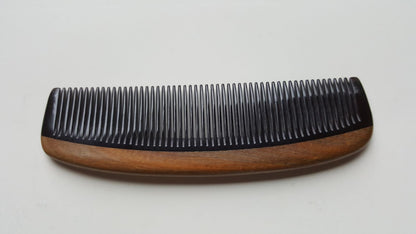 Slightly curved Green Sandalwood horn comb, flat lay side angle highlighting slim profile — Arakicrafts