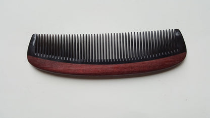 Hand inlaid beard comb flat lay, side angle highlighting Purple Heart wood grain and horn contrast — Arakicrafts