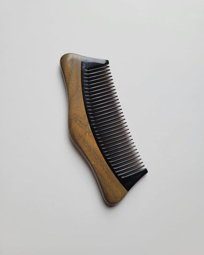 Pocket-sized Green Sandalwood comb for travel and everyday carry, flat lay — Arakicrafts.  The wood grain is visible on the handle, adding to its natural aesthetic.