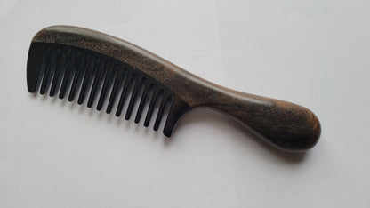 Wide-tooth wood and horn comb — overhead flat lay showing even tooth spacing and natural wood grain detail