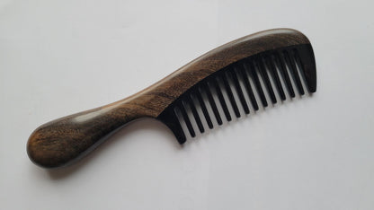 Handcrafted buffalo horn and Chacate Preto comb — close-up of inlay joint where dark wood meets black horn teeth