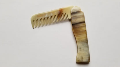 Folding Yak Horn Comb held in hand — curved horn handle, anti-static fine tooth natural comb