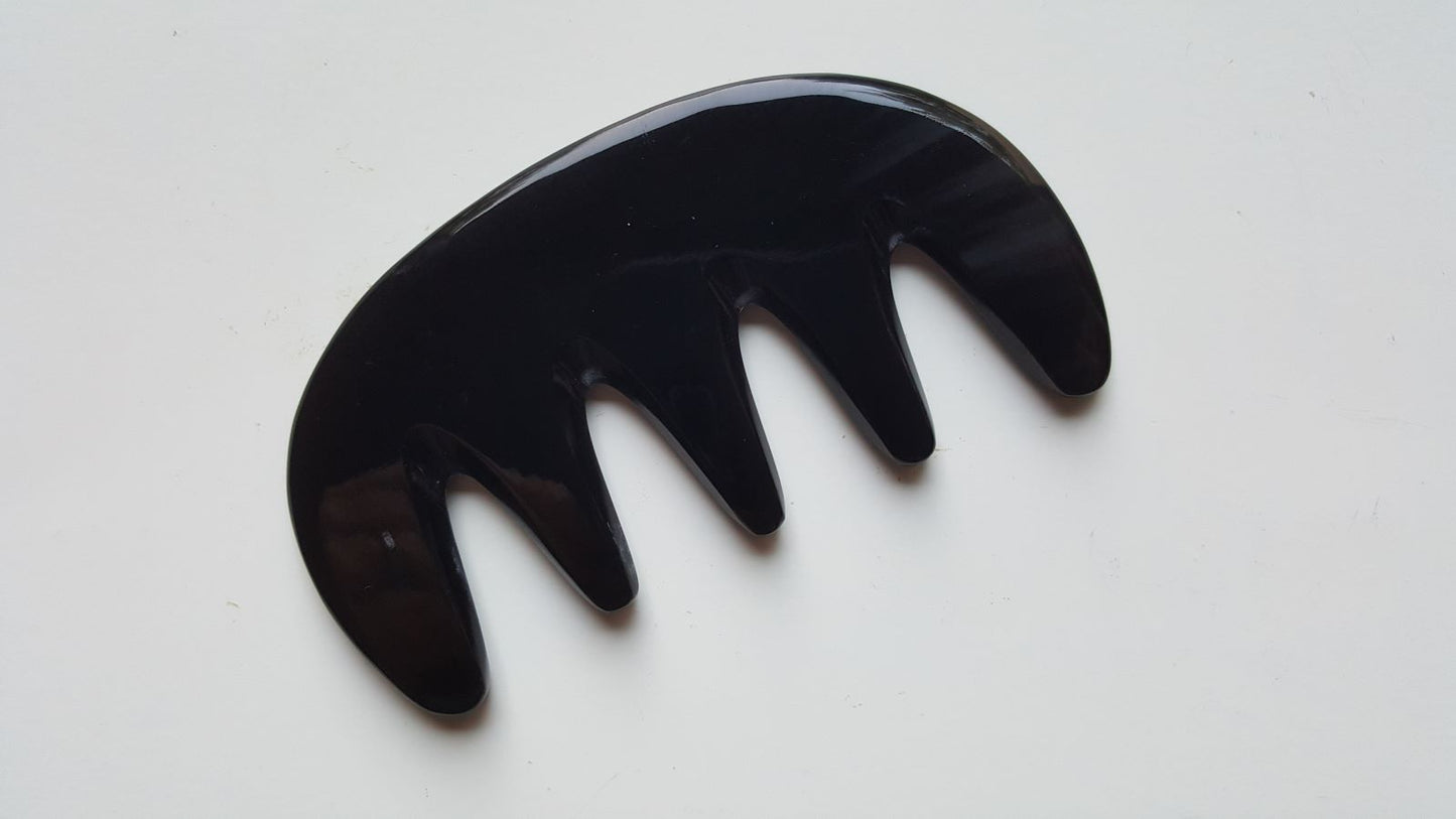 Black yak horn glider comb used as scalp massager — five rounded teeth for tension relief and circulation — Arakicrafts