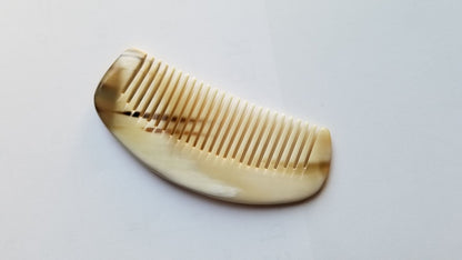 Yak horn mini comb side profile showing crescent body depth, pale cream natural horn, hand-polished fine teeth for snag-free combing
